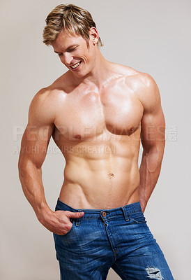 Buy stock photo Cropped shot of a muscular young man posing in studio