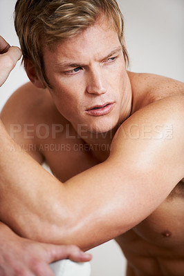 Buy stock photo Man, shirtless and muscle in studio or white background for confident masculine, strong body or bodybuilder pride. Male person, model and topless for bicep arms or shoulders, attractive in Norway