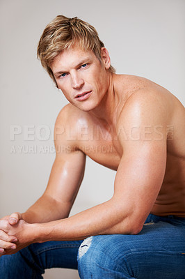 Buy stock photo Portrait, fashion and body of a masculine man in studio isolated on a gray background for fitness or health. Skin, sexy and a confident young model looking serious while shirtless for macho style