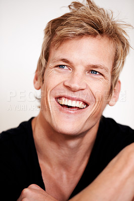 Buy stock photo Cropped shot of a handsome young man posing in studio