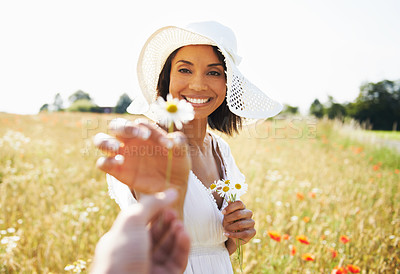 Buy stock photo Woman, flowers and countryside with a gift, nature and plants with vacation, summer and relax. Present, person and girl with a hat, sunshine and break with holiday, field and spring with happiness