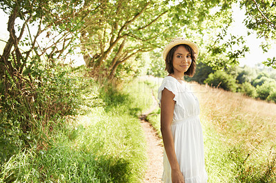 Buy stock photo Portrait, smile and woman in the countryside on vacation, summer holiday and travel in woods. Happy person in dress, hat and nature outdoor at forest, garden field and grass path to relax in Brazil