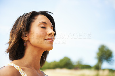 Buy stock photo A pretty woman with her eyes closed outdoors