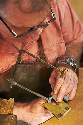 Buy stock photo Top view of a goldsmith about to saw into a piece of metal 