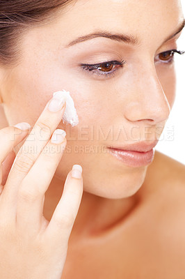 Buy stock photo Face cream, application and woman in studio for skincare, wellness or cosmetics closeup. Facial, sunscreen and female model with luxury skin product, lotion or spf, anti aging and collagen treatment