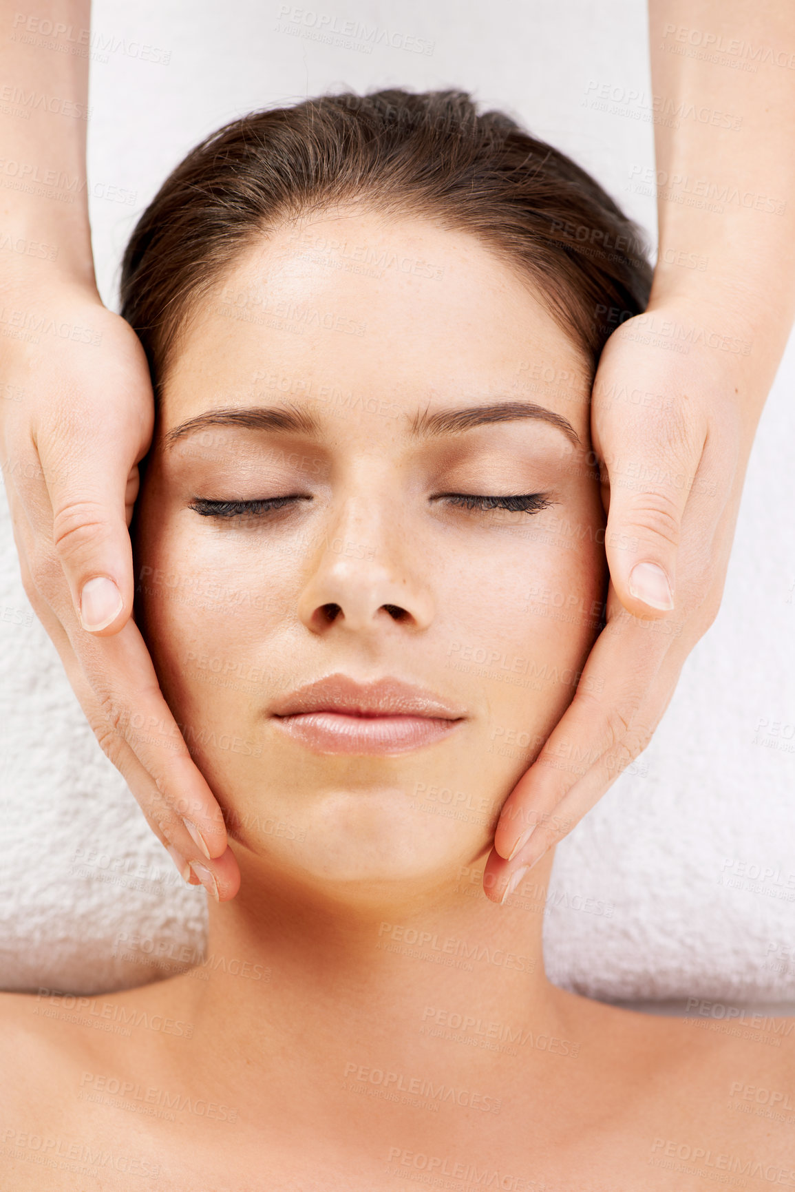 Buy stock photo Spa, massage and hands on face of woman from above at a resort for stress relief, pamper or treatment. Top view, facial and female with masseuse at a beauty salon for luxury, skincare or dermatology