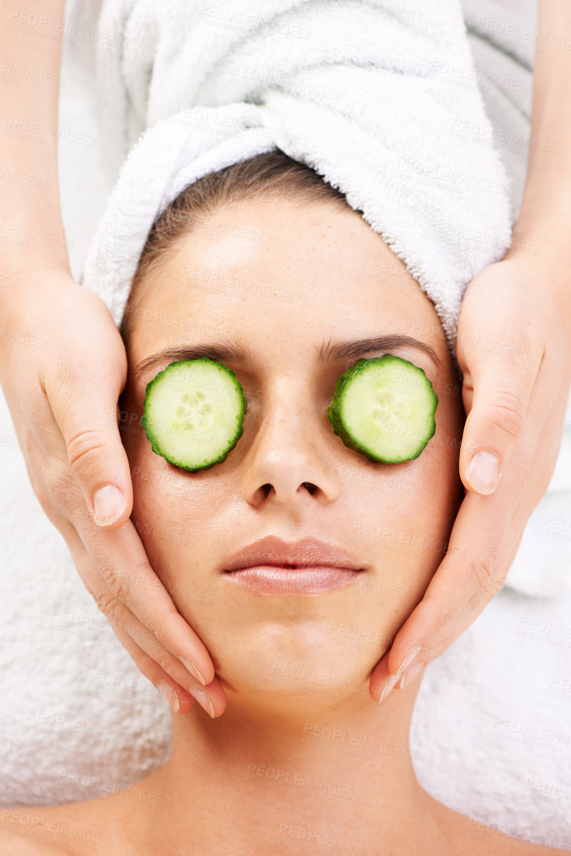 Buy stock photo Spa, facial and woman with cucumber for massage, salon treatment and care on towel. Skincare aesthetic, dermatology and masseuse with above of person for relax, calm and wellness for luxury cosmetics