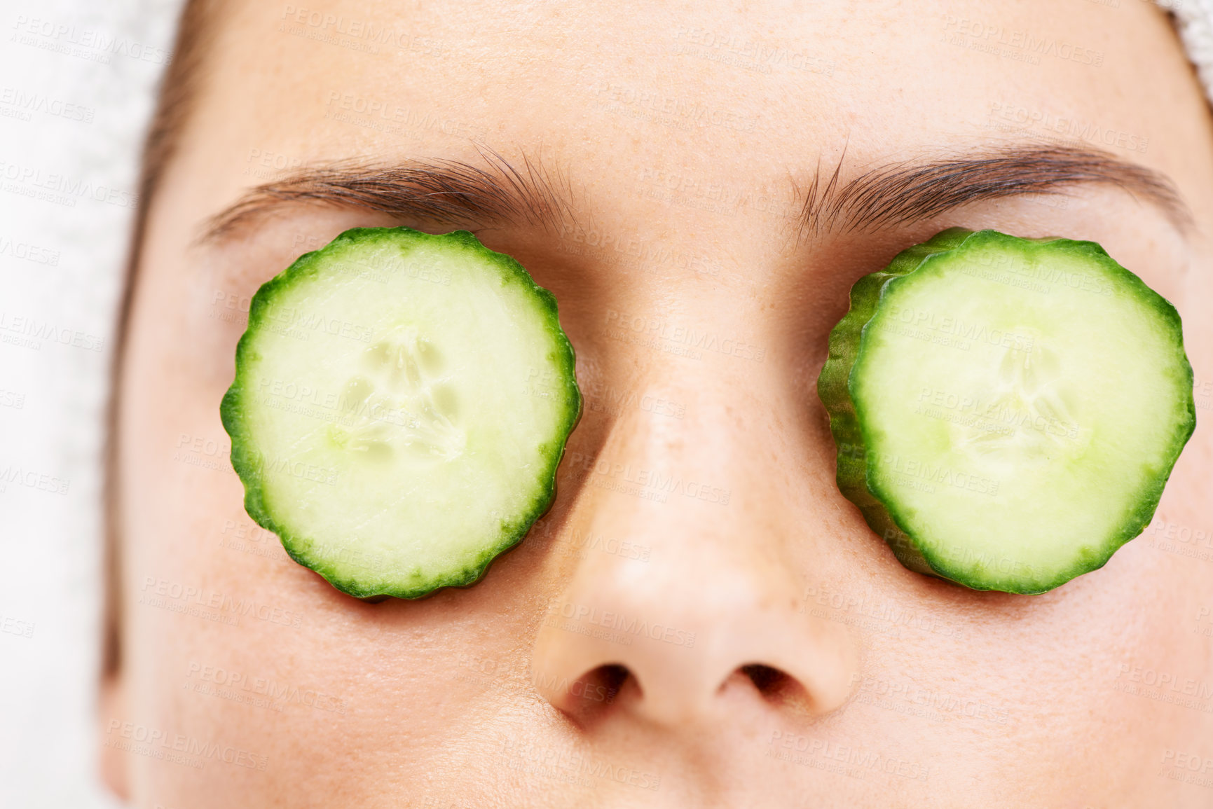 Buy stock photo Woman, face and cucumber on eyes for wellness, cosmetic or spa therapy with closeup, relax and peace. Person, skincare or detox treatment for beauty, skin or stress relief and relaxation or wellbeing