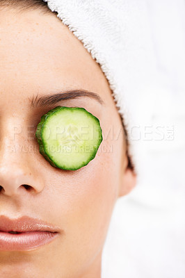 Buy stock photo Woman, face and cucumber on eye for wellness, cosmetic or spa therapy with closeup, relax and peace. Person, skincare or detox treatment for beauty, skin or stress relief and relaxation or wellbeing
