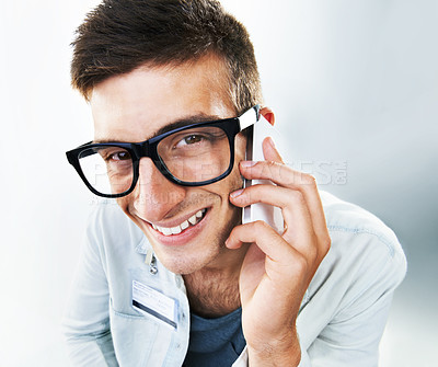 Buy stock photo Man, cellphone and smile for closeup, communication and name tag for business, networking and studio background. Glasses, worker and portrait for company, technology and conversation on mobile call