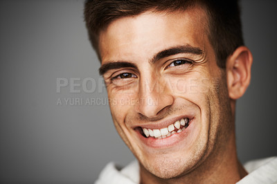 Buy stock photo Portrait, smile of man and student in studio isolated on a gray background mockup space. Face, happy young person and model with positive facial expression, excited and cheerful in Spain at college