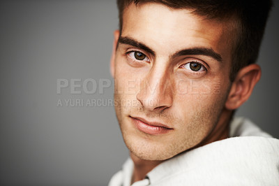 Buy stock photo Portrait, man and serious for facial expression in studio for mock up on gray background in Spain. Alone, male model or student in college, university or school with confident look on face in closeup