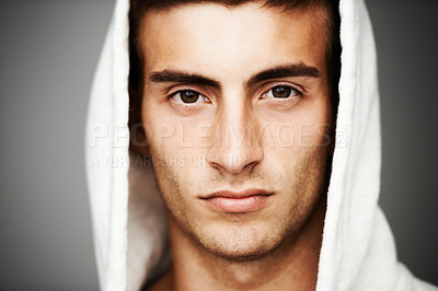 Buy stock photo Confident, portrait and man in hoodie for fashion isolated on a gray background. Serious young person, face of model and streetwear clothes, casual and cool facial expression in Spain on a backdrop