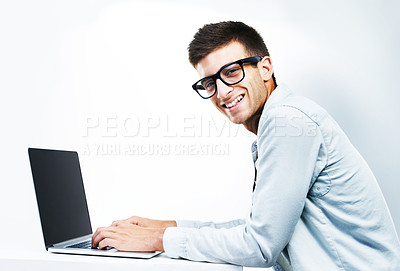 Buy stock photo Portrait, business man typing on laptop at table and isolated on white background. Face, smile and geek at desk on computer, technology and IT programmer in glasses, coding and mockup space in Canada
