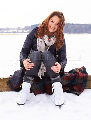 Buy stock photo Pretty teenage girl ready to go ice skating on a natural frozen lake outdoors