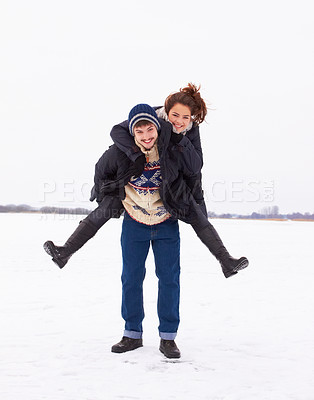Buy stock photo A cute young couple being playful in on the ice of a frozen natural lake