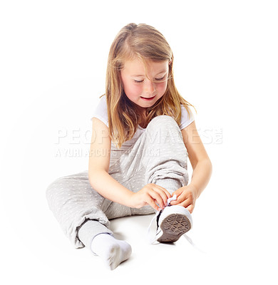 Buy stock photo Shoes tie, kid and casual fashion with sneakers and youth with modern clothing in studio. Sitting, ground and young girl with socks and footwear with a smile from learning with white background