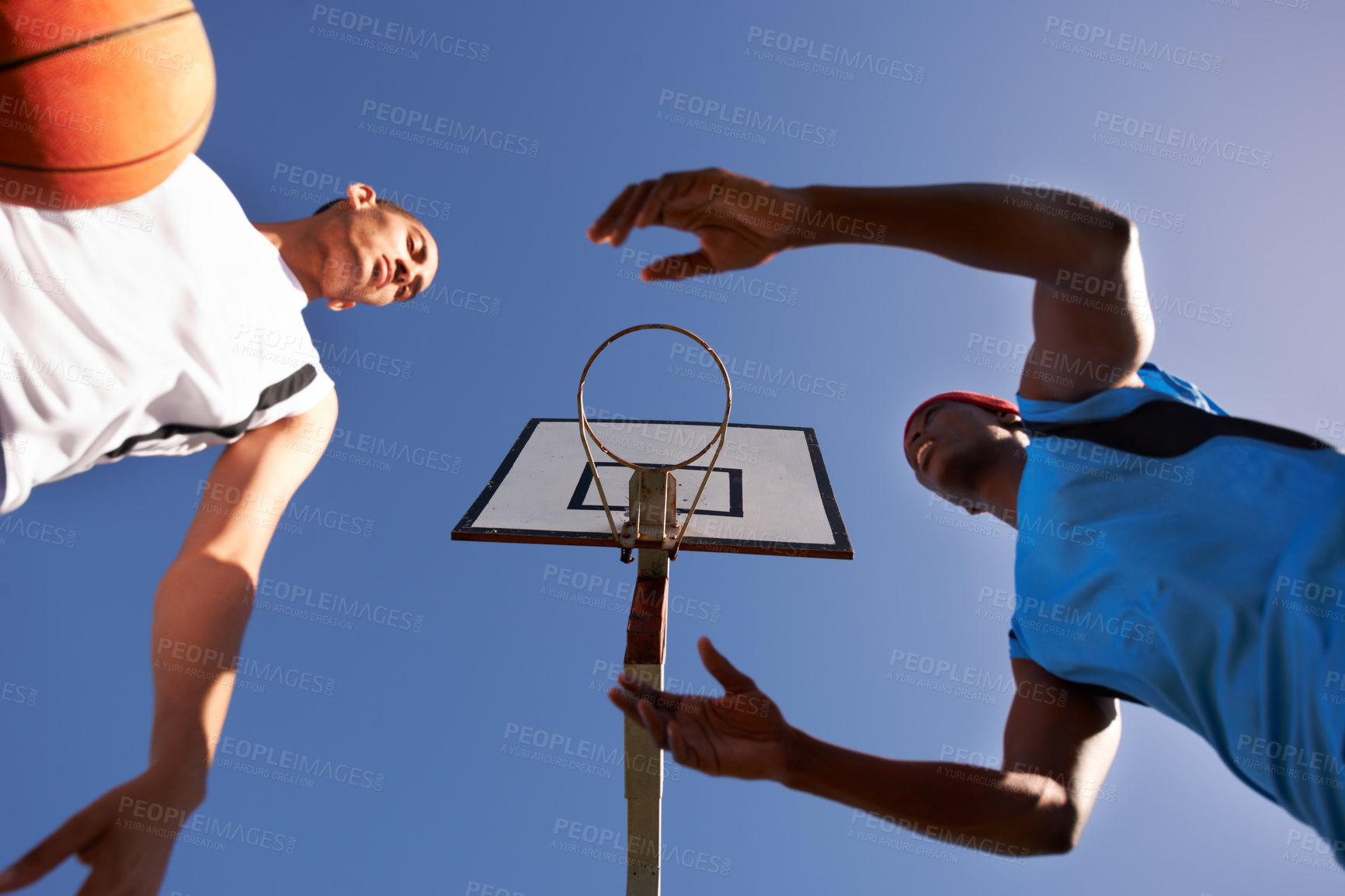 Buy stock photo Men, player and basketball match at outdoor court or low angle of challenge team, dunk on rival. Male people, hoop and score point in summer park at fitness game or competition, athlete on blue sky