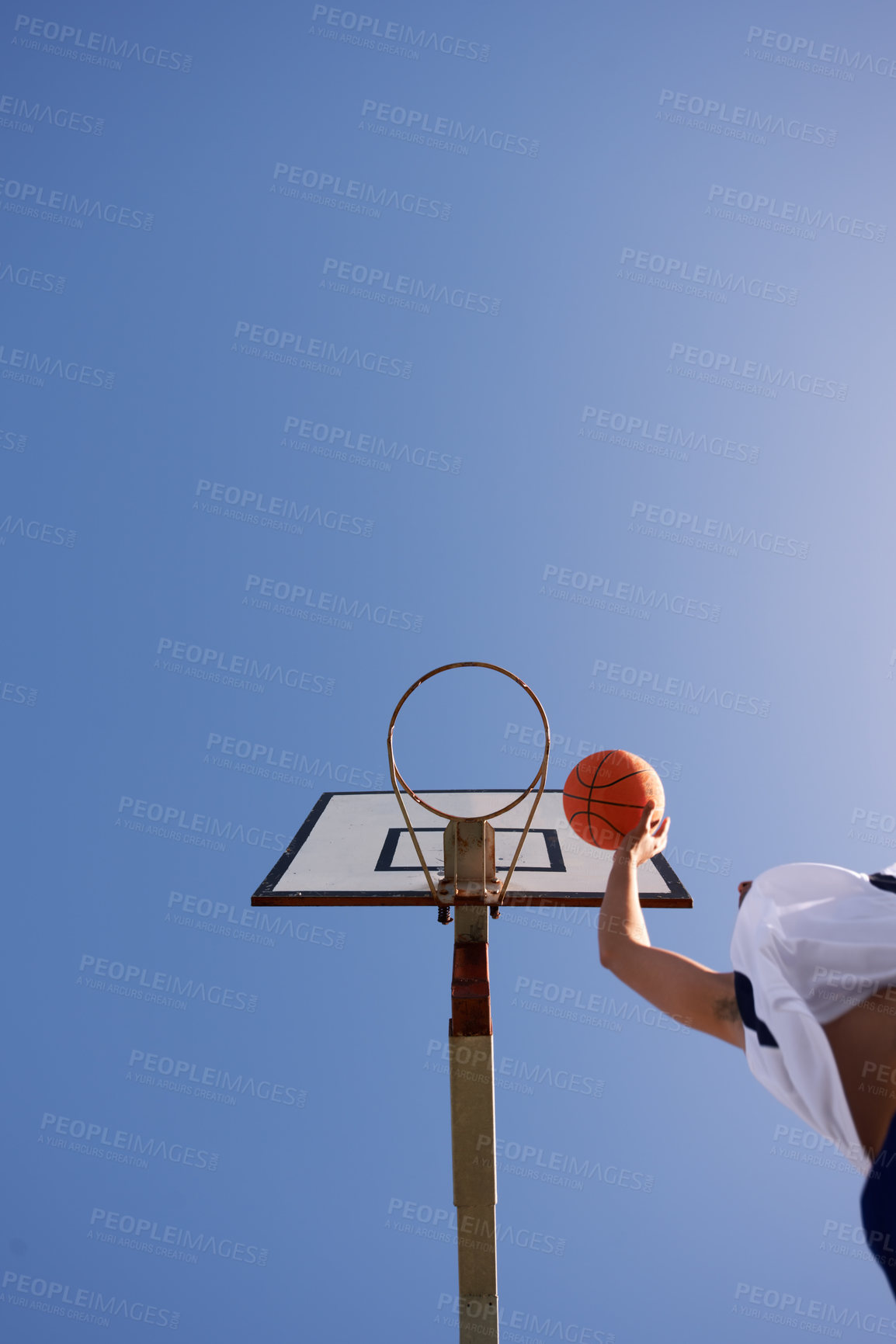 Buy stock photo Man, basketball and low angle shot for point as jump athlete, game challenge or sky mockup. Male person, hand and string dunk score at hoop for exercise fun or fitness training sport, player on court