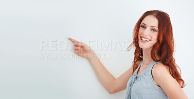 Buy stock photo Portrait, happy woman and smile for pointing in studio for presentation mockup for on white background in Ireland. Female model, expression or excitement on face for announcement, offer or promotion
