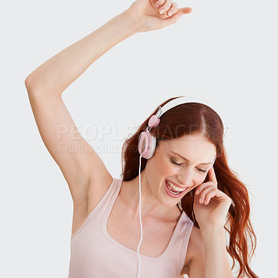 Buy stock photo Young woman, headphones and dance in studio with music, streaming and happiness by wall background. Girl, student or isolated model with listening to audio app, sound and internet radio for dancing