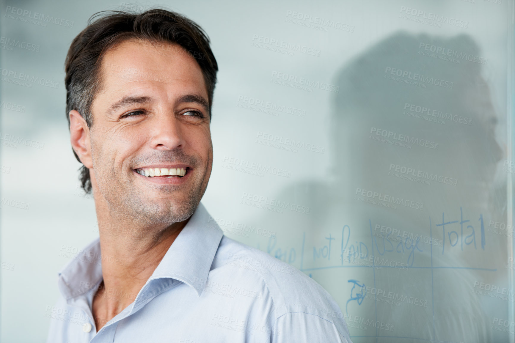Buy stock photo Happy businessman, face and smile for vision, ambition or success on mockup at the office. Man employee smiling in happiness for career goals, planning or corporate achievement at the workplace