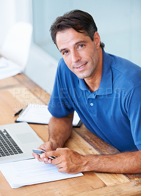Buy stock photo Mature man, smile and portrait in office, phone and connection to internet, networking and desk. Happy male person, laptop and website for mobile app, research and positive for schedule or online