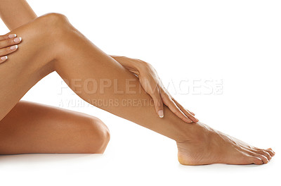 Buy stock photo Hand, woman and legs during skincare, luxury and hygiene treatment against a white background. Beauty, leg and girl model relax in studio for cleaning, wellness and grooming while touching soft skin