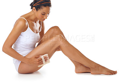 Buy stock photo Woman, beauty and exfoliate legs on studio, white background and aesthetic wellness. Body care, exfoliation and cleaning for leg cosmetics, massage sponge and healthy skincare of soft texture results