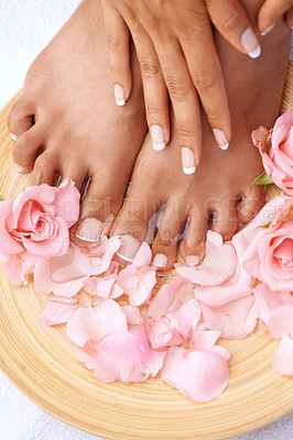 Buy stock photo Beauty treatment, skincare and feet of a woman with flowers for cleaning, pedicure and detox. Spa, dermatology and foot and hands of a model with a floral, cosmetic and natural manicure with roses