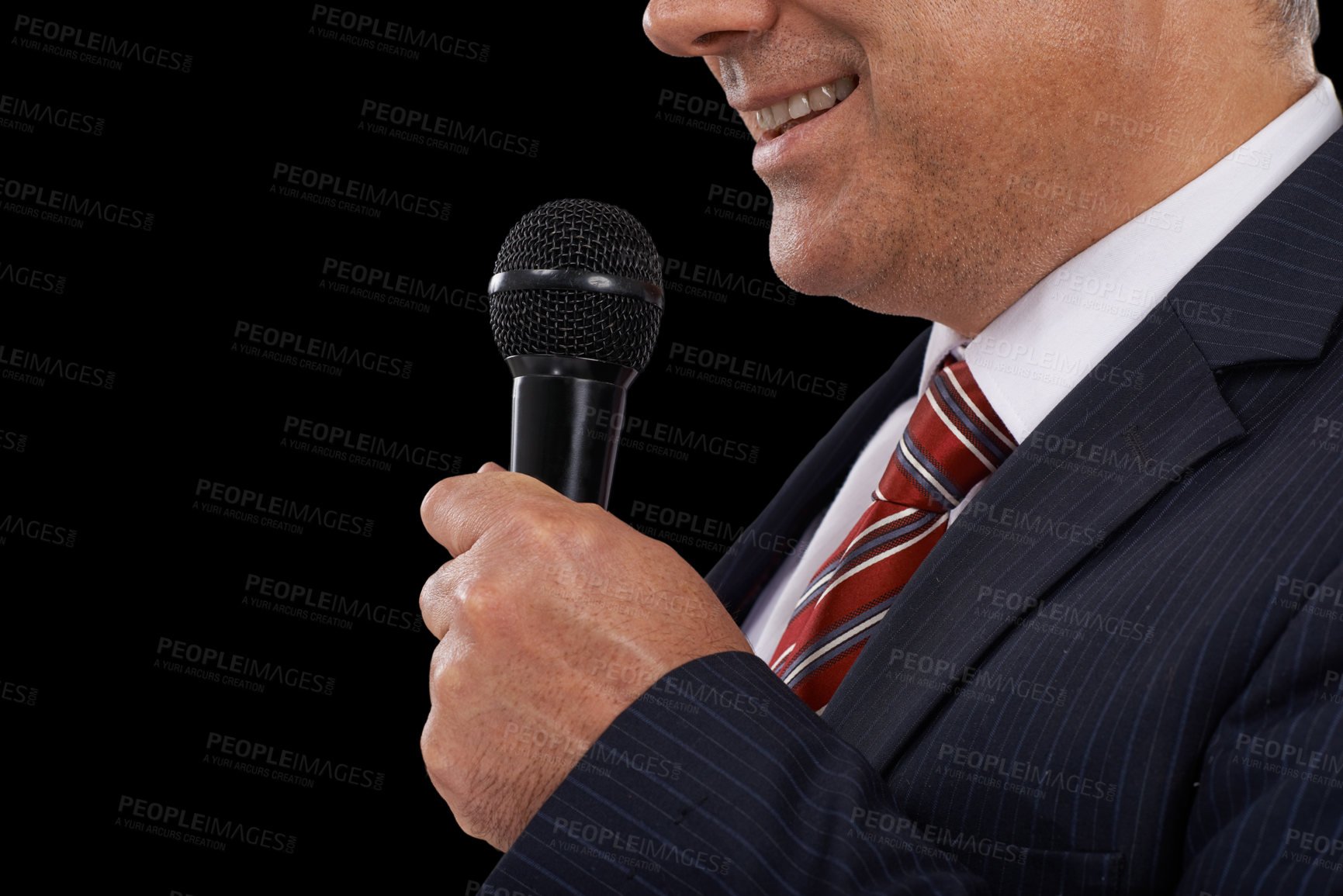 Buy stock photo Cropped image of a mature man in a suit speaking into a microphone