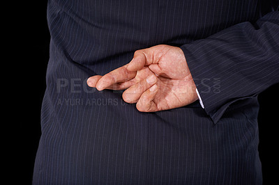 Buy stock photo Closeup, business and man with fingers crossed, fraud and lawyer with oath, corrupt and dishonesty. Person, corporate professional or model in a suit, hand gesture or liar on a dark studio background