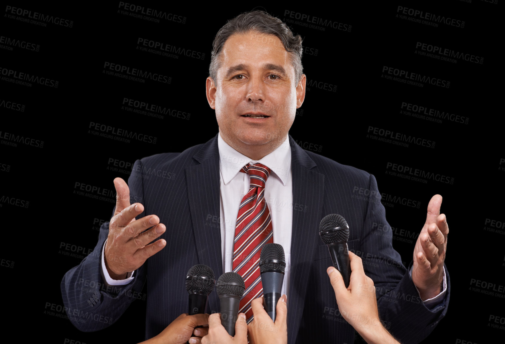 Buy stock photo Portrait of a mature man giving a press conference on a black background