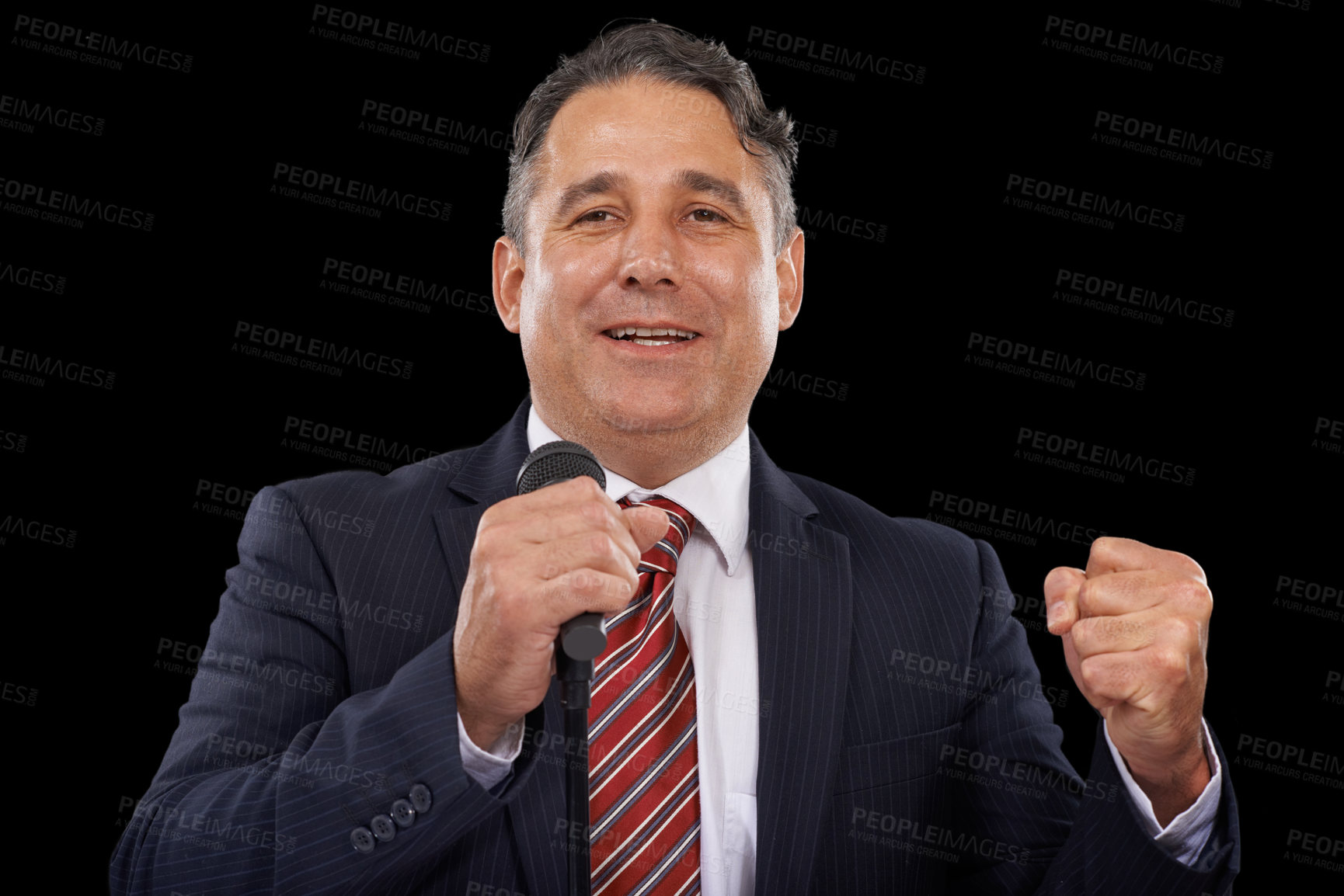 Buy stock photo A man in a suit giving a speech while holding a microphone