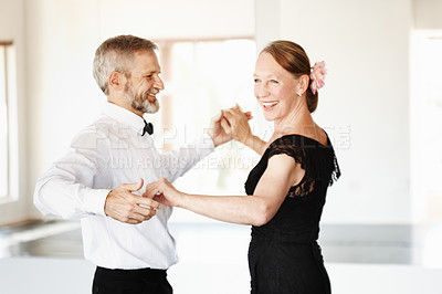 Buy stock photo Shot of a mature couple dancing together in formal attire