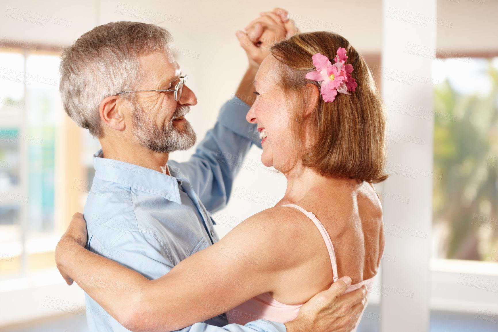 Buy stock photo Senior couple, dancing and happy in house, love and ballroom for fun, touch and romantic. Retirement, bonding together and smile for husband, wife and flower with tango, retired or elderly people
