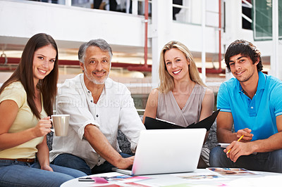 Buy stock photo Portrait of a team of designers sitting around a laptop