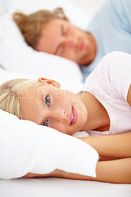 Buy stock photo Portrait, wake up and a couple in bed in the morning to relax in their home together on the weekend. Face, sleep or rest and a young woman in the bedroom with her boyfriend for honeymoon bonding