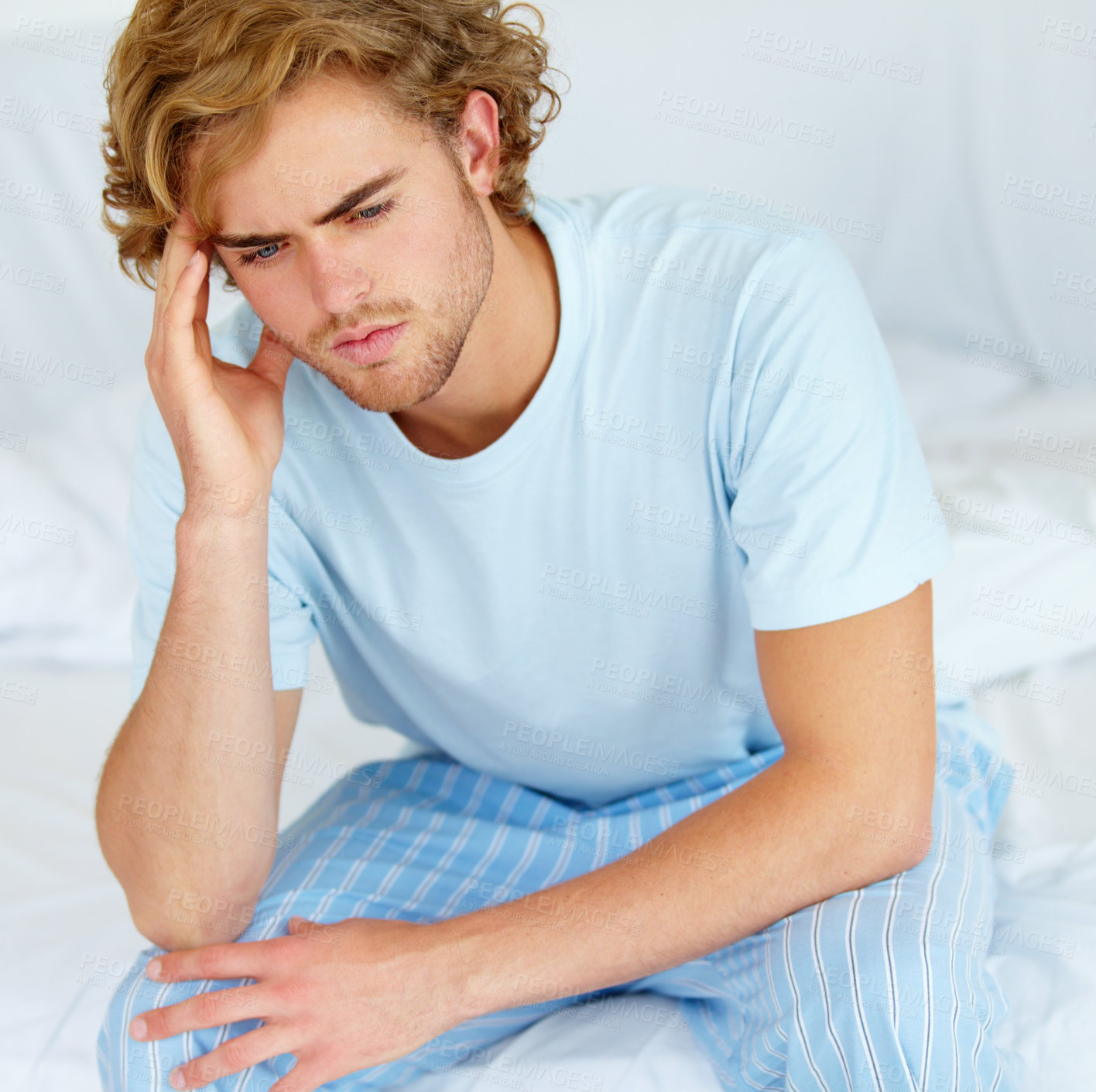 Buy stock photo Stress, thinking and exhausted with a man on his bed in the morning to wake up feeling moody. Depression, mental health or burnout with a tired young person alone in the bedroom of his apartment