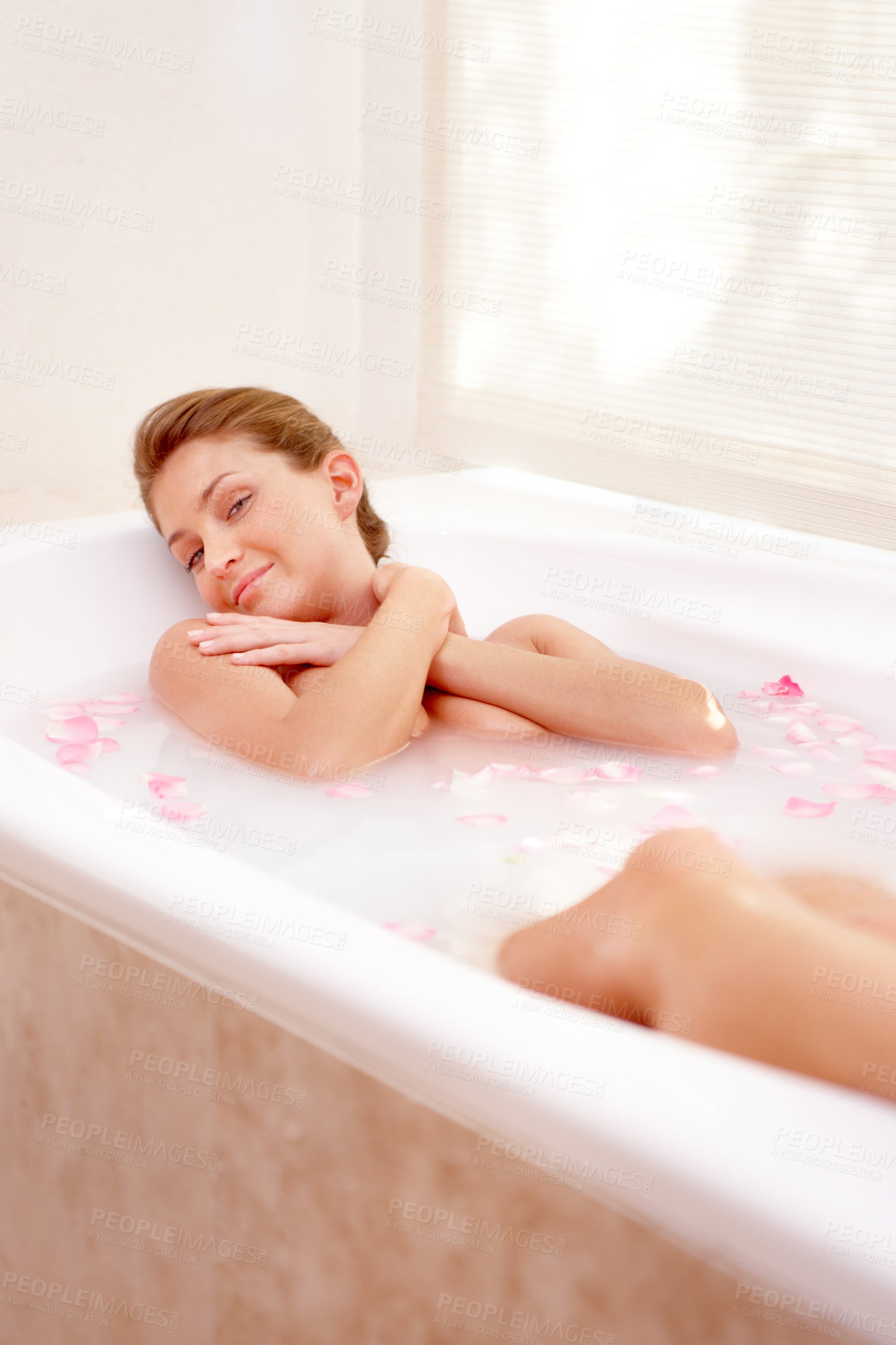 Buy stock photo Woman portrait, rose and milk bath with flower petals and luxury bathroom treatment. Beauty body care, cleaning and female person relax in home with floral aromatherapy and natural wellness wash