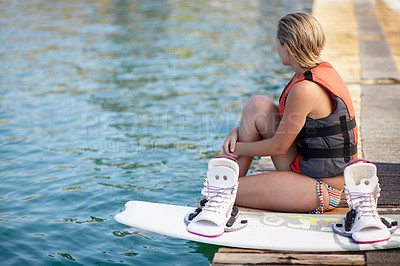 Buy stock photo Woman, ready or wakeboard by water, lake or ocean sea with ideas, vision and planning fitness hobby. Person, life jacket and thinking athlete with swimsuit, exercise and training equipment for sports