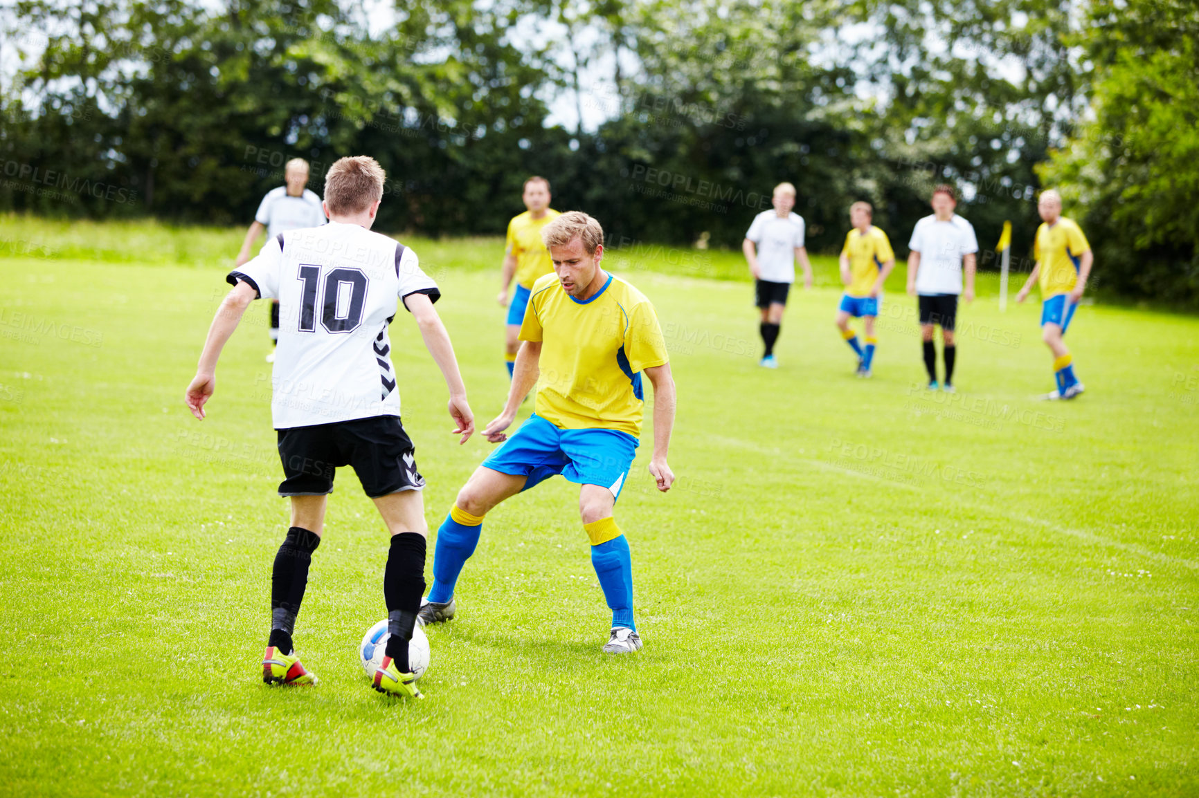 Buy stock photo A group of soccer players in the middle of a game