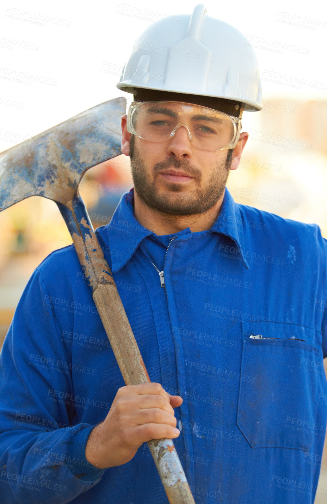 Buy stock photo Portrait of a construction worker with his shovel over his shoulder