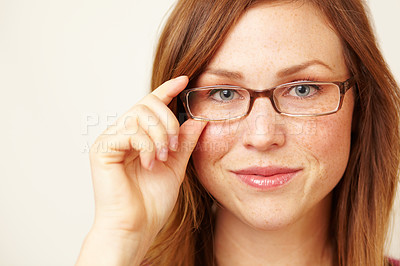 Buy stock photo Cropped portrait of a beautiful young redhead wearing glasses