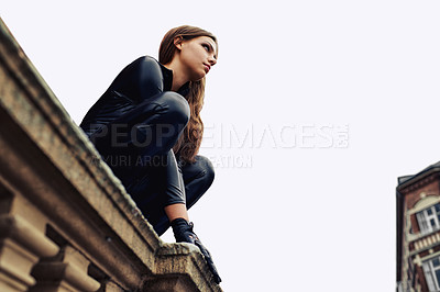 Buy stock photo Woman, leather catsuit and roof in city for superhero character, thinking and vigilante. Girl, cosplay clothes and fashion for criminal, spy or agent on balcony for mystery, vision or mission