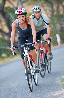 Buy stock photo Shot of a couple focused on their bicycle ride together