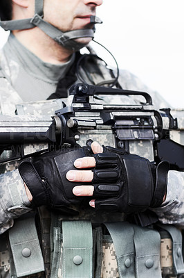 Buy stock photo Closeup cropped shot of the midriff of a soldier holding his gun against his chest