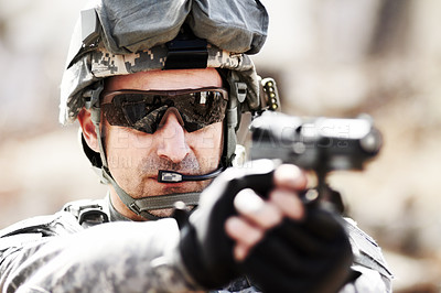 Buy stock photo Closeup head and shoulders shot of a soldier pointing his hand gun