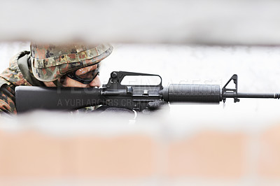 Buy stock photo Profile of a soldier aiming a gun with a slot in the foreground