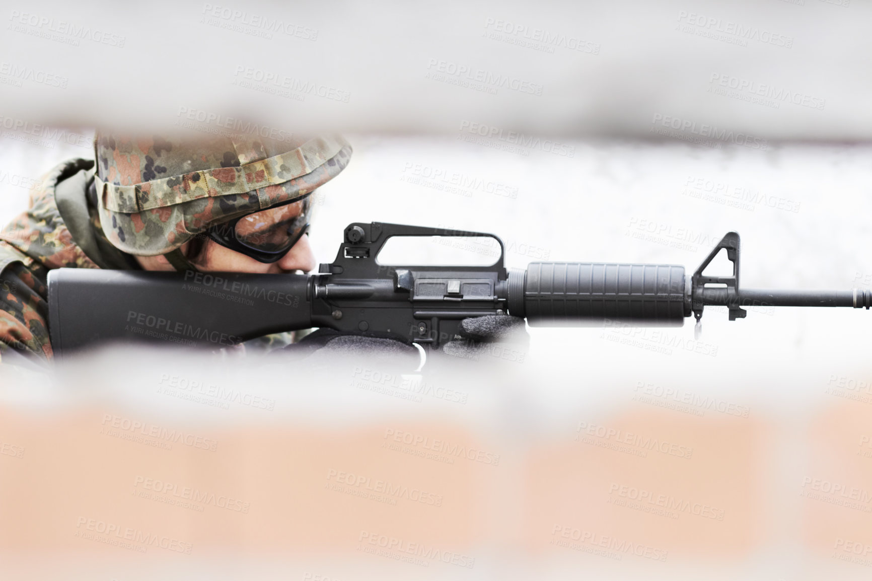 Buy stock photo Profile of a soldier aiming a gun with a slot in the foreground